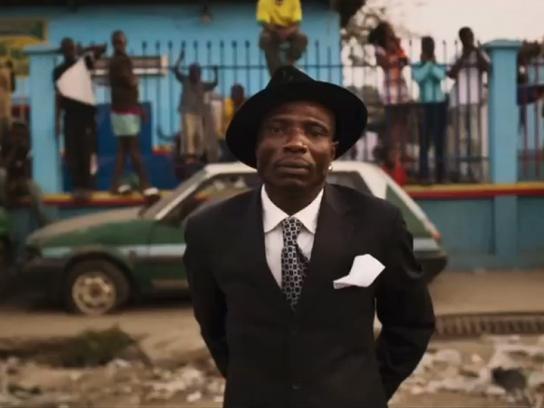 A Sapeur from Guinness's Sapeurs campaign, in a bright tailored suit in Brazzaville